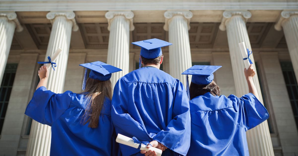 Students in blue caps and gowns at high school graduations prepped with college and career readiness lessons.